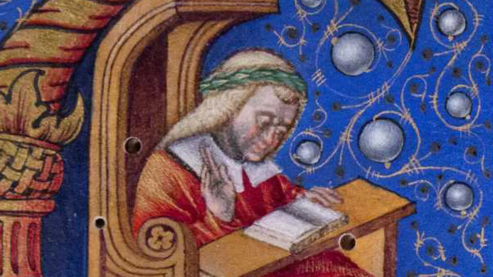 Initial from a medieval manuscript depicting a man reading
