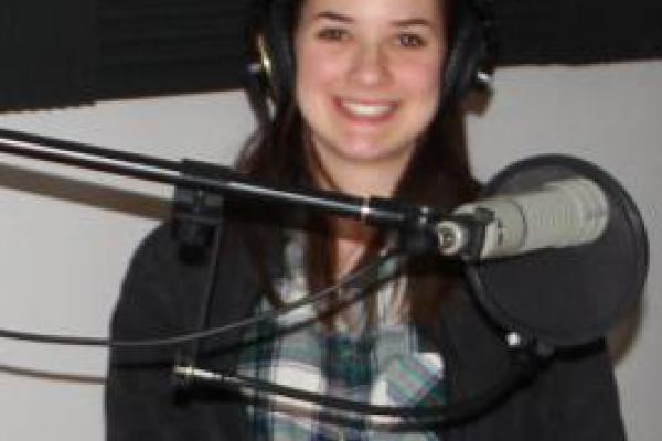 A radio broadcast Modern Greek student with radio microphone